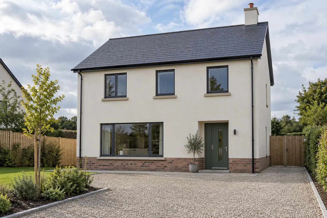 Finished two-storey white-rendered house with gravel driveway
